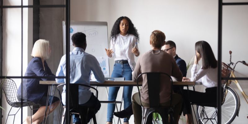 Woman leading a team discussion around an office table